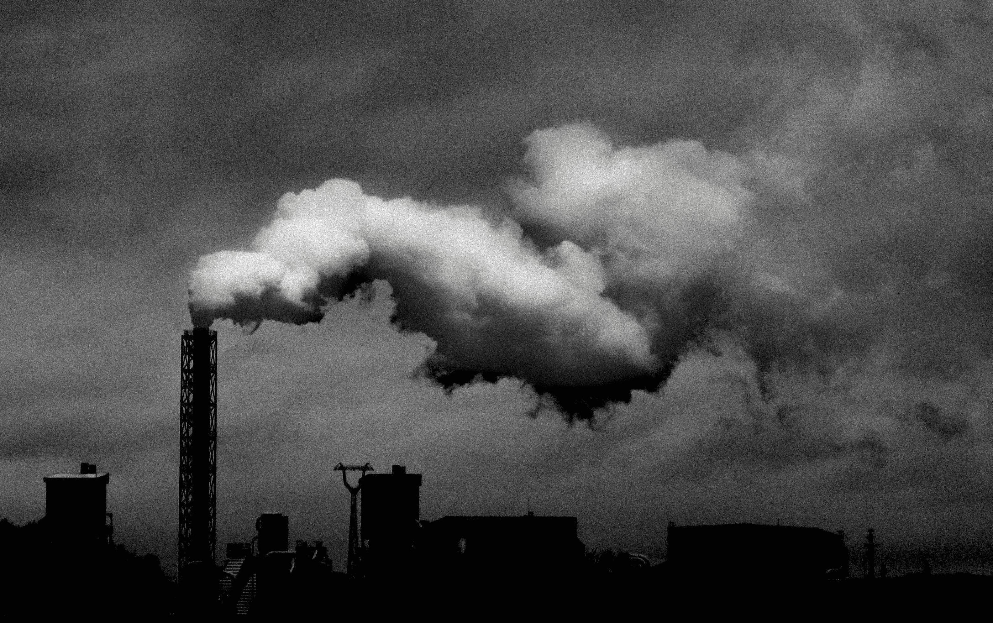 A bleak scene of a funnel producing smog