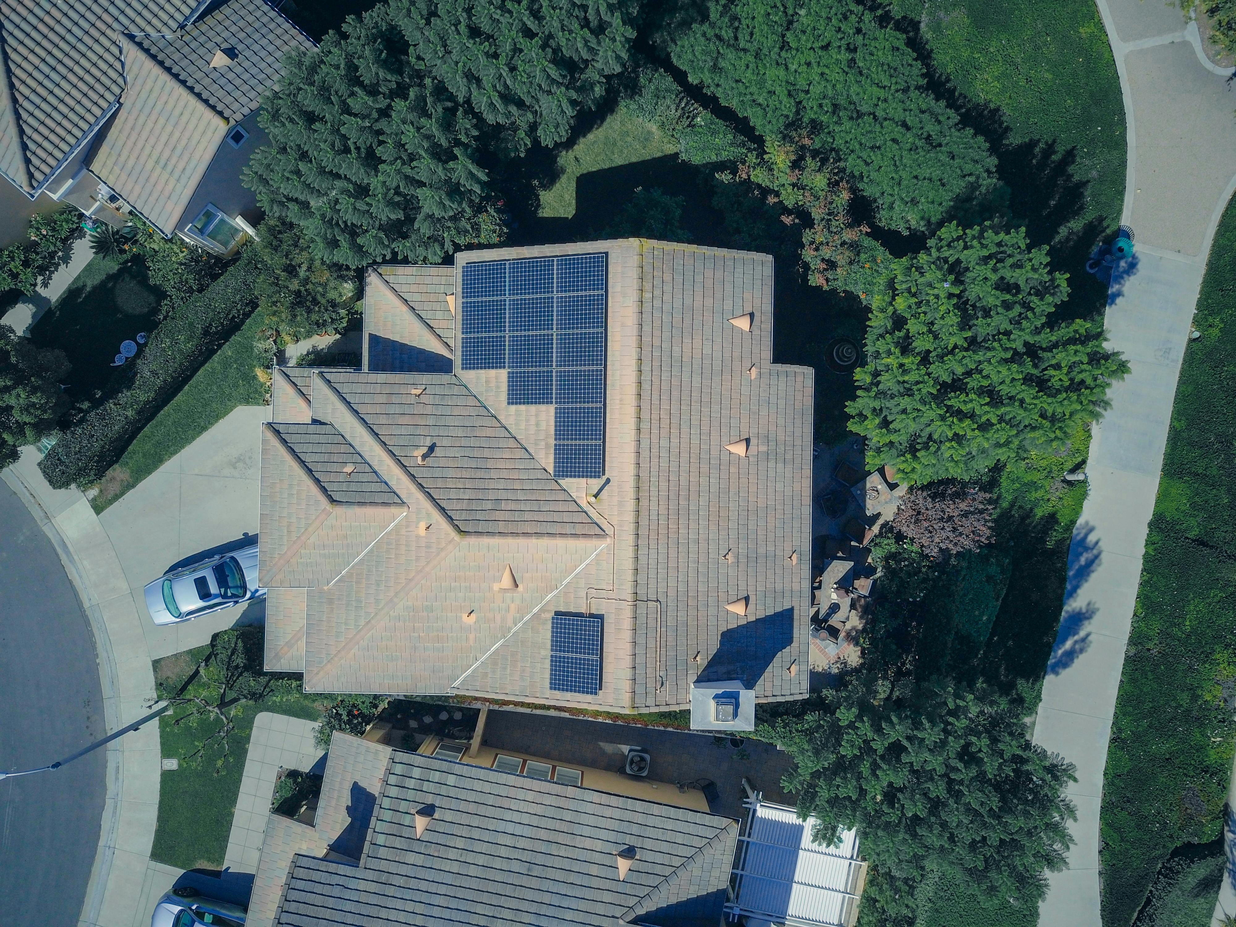 A beautiful arial view home wih solar panels.